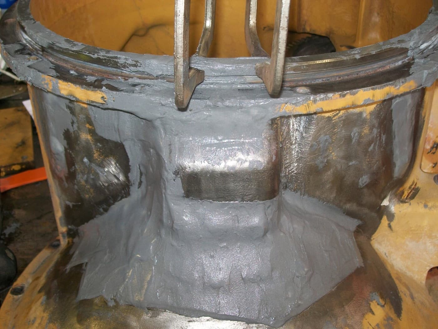 Belzona cold-applied composite rebuilding worn metal on industrial equipment in the field